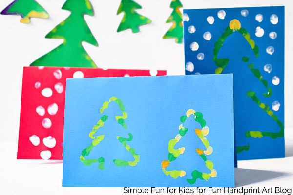 Have you tried the fingerprint resist technique? It's super simple for kids of all ages and comes out looking great! Get the free printable template to make these Fingerprint Christmas Tree Christmas Cards three different ways!