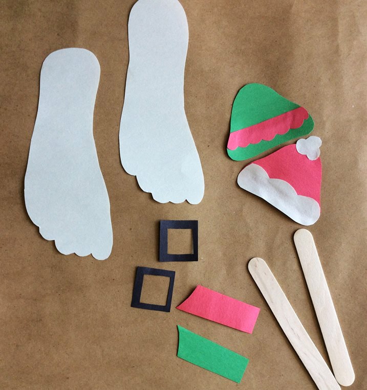 Bring Santa & His Elf To Life With These Stick Puppets Made With Footprints. Perfect Christmas Craft For Home or the Classroom