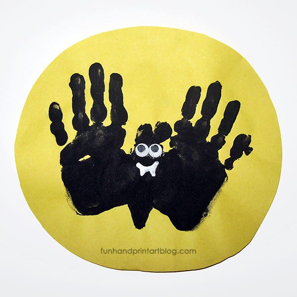 Adorable Handprint Bat Flying Over the Moon Halloween Craft for toddlers, preschoolers, and kindergarteners to make this Halloween. 